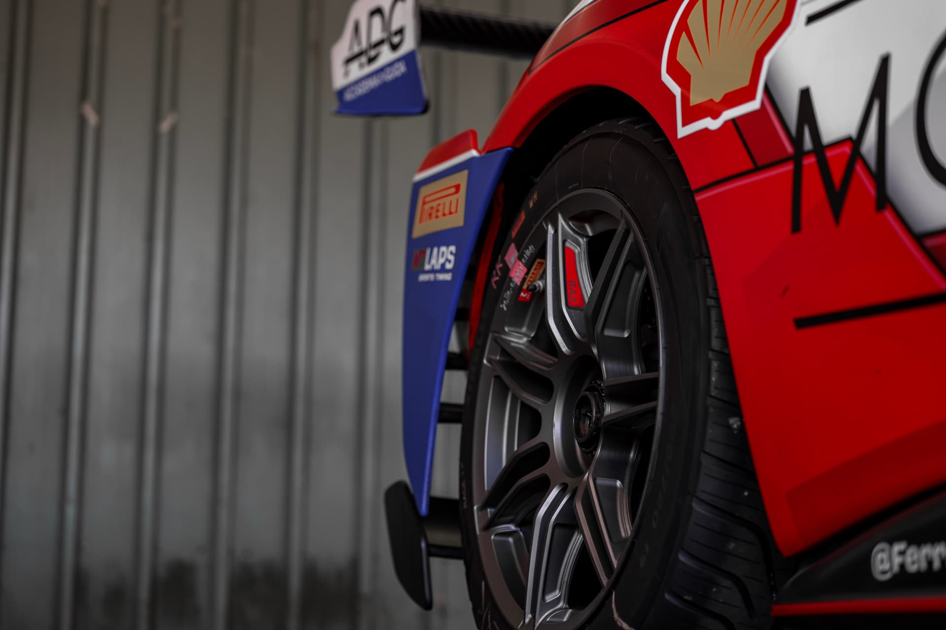 Ferrari race wheel and bodywork in the garage