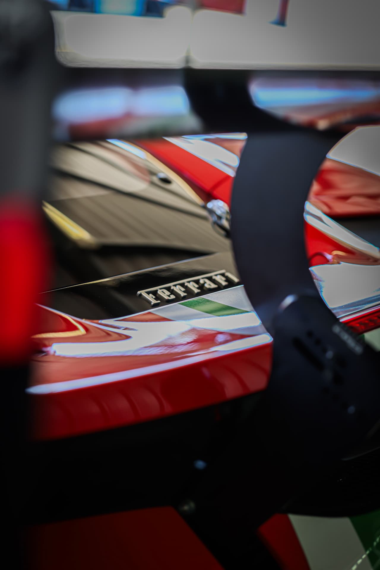 Ferrari badge and Italian stripe seen through pit equipment