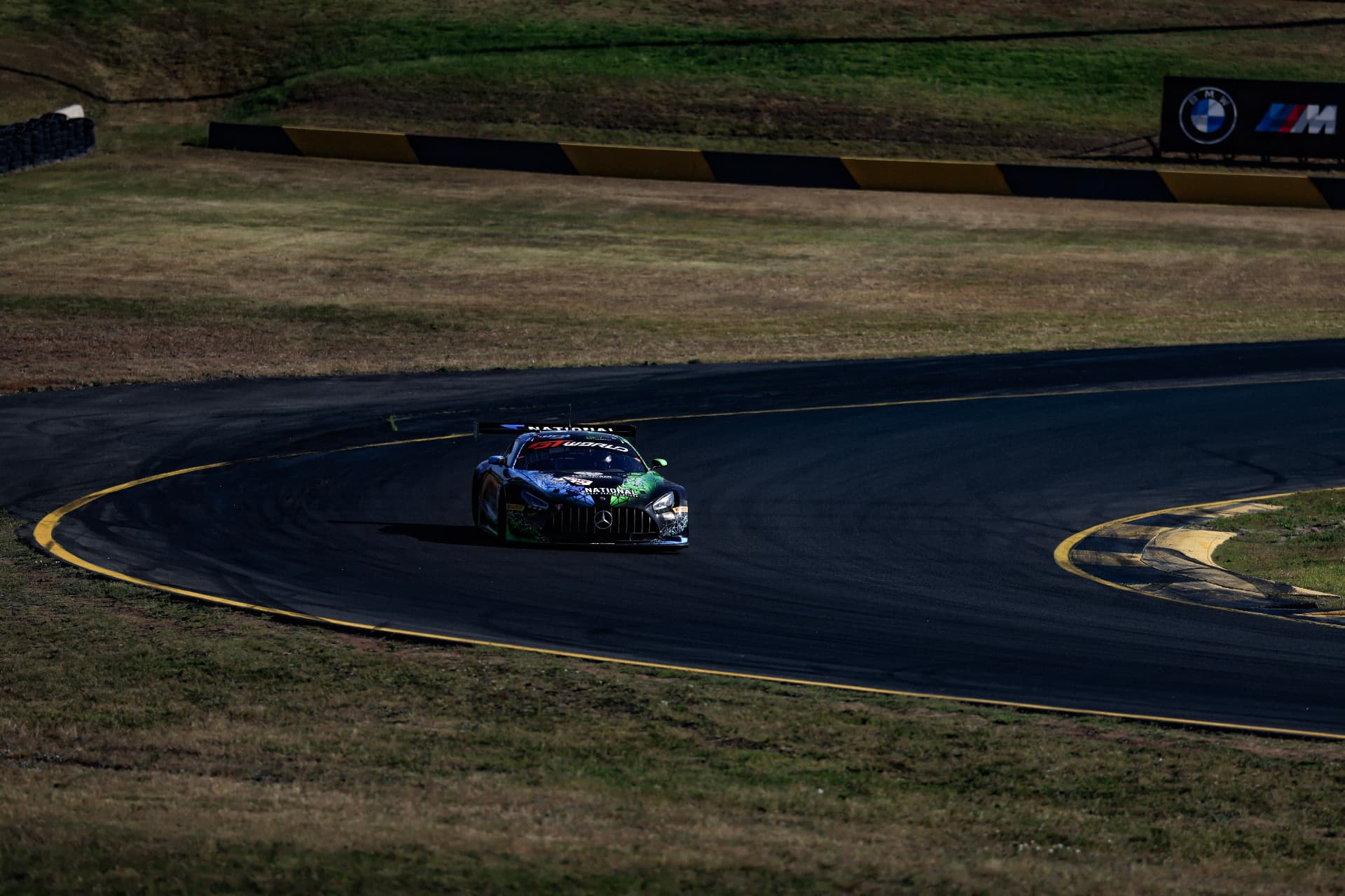 Mercedes-AMG GT car entering a shadowed circuit corner