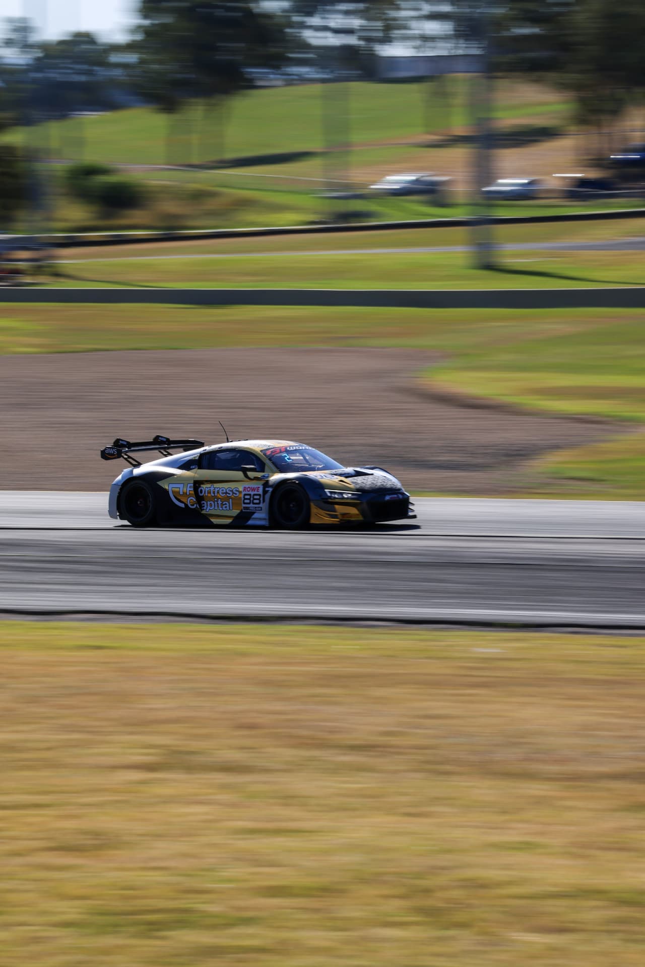 Audi R8 GT car sharp against a streaked circuit background during a pan