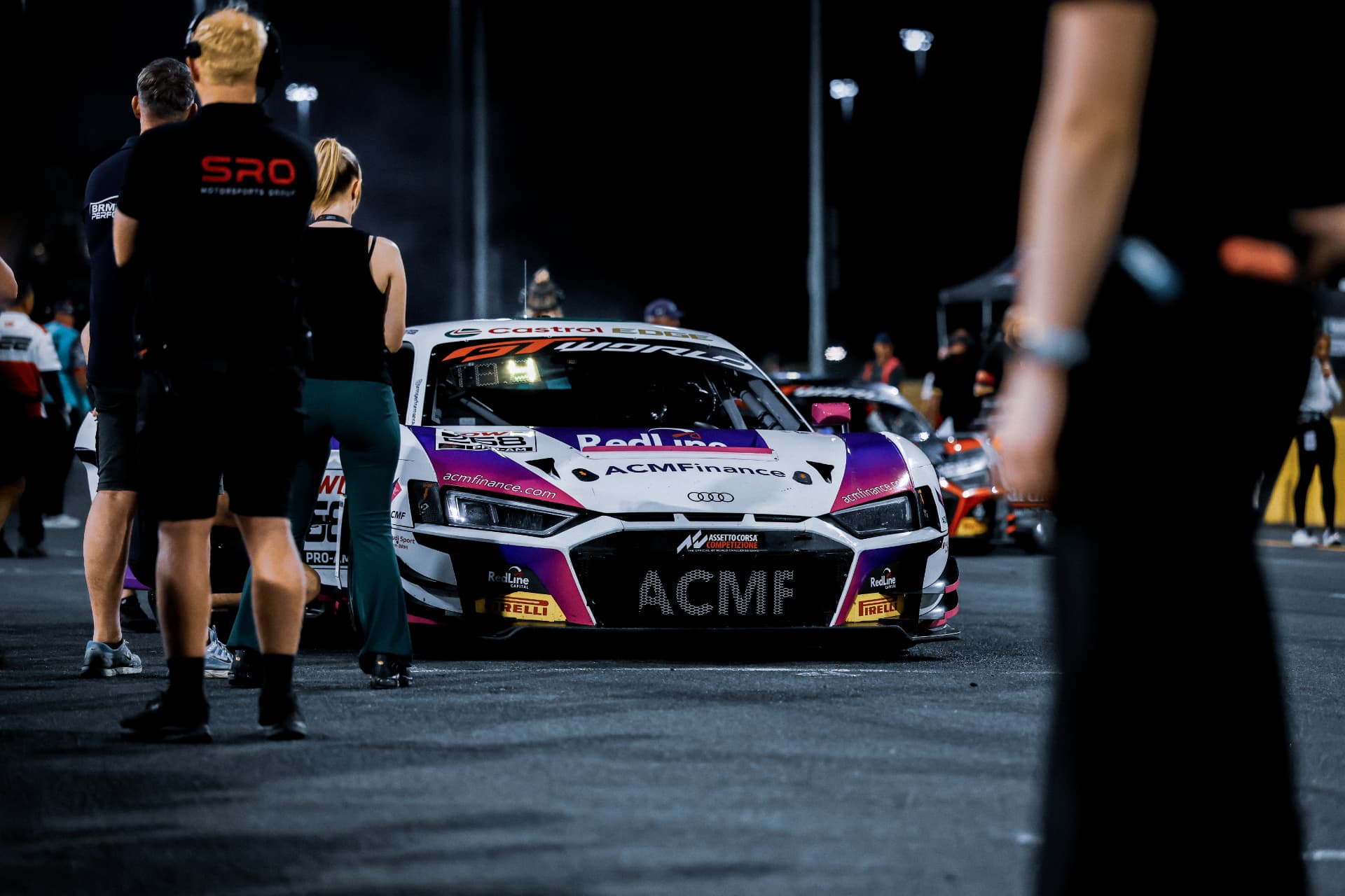 ACMF Audi R8 GT car on the night grid surrounded by crew