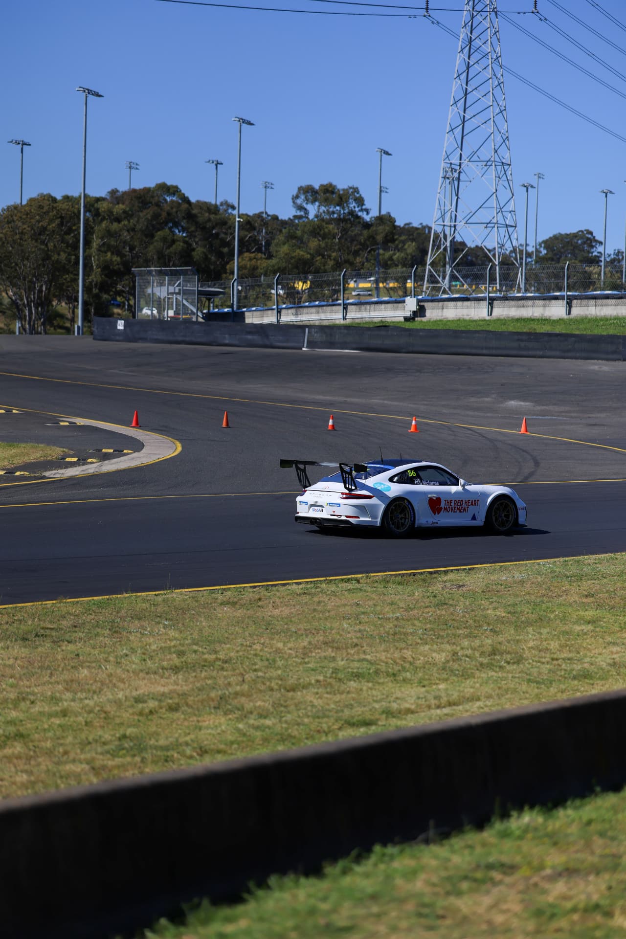 White Porsche race car turning through the circuit