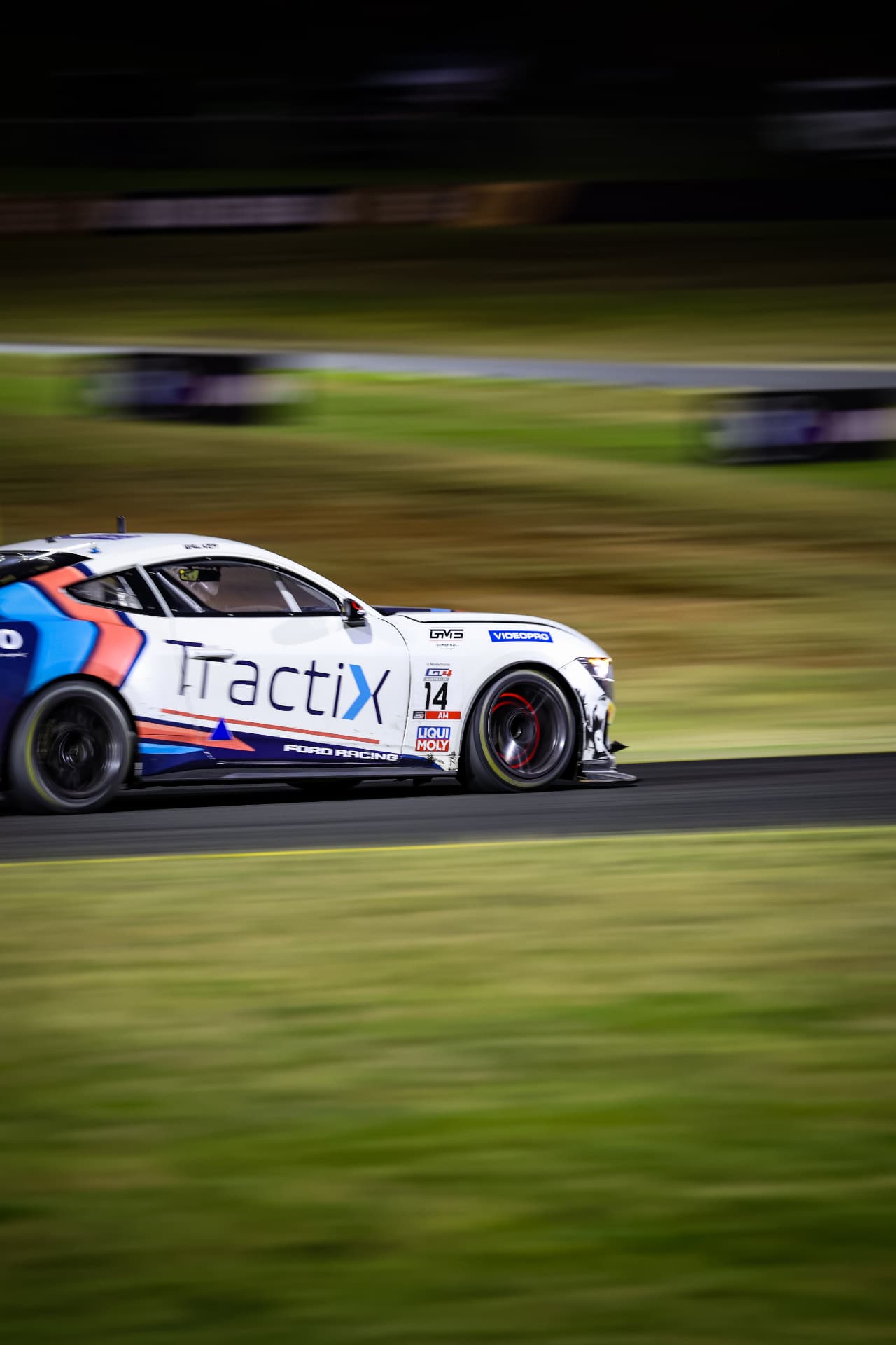 Tractix Ford Mustang GT4 #14 panned against a blurred infield